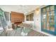 This porch has an oval table and chairs and a wooden blind, offering a serene retreat for outdoor enjoyment at 809 40Th St, Sarasota, FL 34234