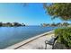 A waterfront view features a scenic seating area, providing a tranquil place to relax and enjoy the peaceful water views at 809 40Th St, Sarasota, FL 34234