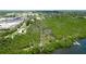 A beautiful aerial view of the property featuring a private dock, lush greenery, and the serene waterfront at 9403 9Th Nw Ave, Bradenton, FL 34209