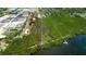 A captivating aerial view showcasing the property's layout, waterfront access, and lush green surroundings at 9403 9Th Nw Ave, Bradenton, FL 34209