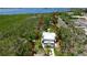 Aerial view shows boundaries of waterfront property amidst lush vegetation and serene water at 9403 9Th Nw Ave, Bradenton, FL 34209