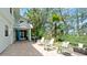 Lush backyard with brick patio, seating, mature trees, and a serene outdoor living space at 9403 9Th Nw Ave, Bradenton, FL 34209