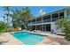 Relaxing backyard pool with a spacious patio, grill, and lush tropical landscaping at 9403 9Th Nw Ave, Bradenton, FL 34209