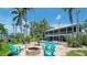 Spacious backyard with a fire pit, lounge chairs, a pool and lush trees for outdoor enjoyment at 9403 9Th Nw Ave, Bradenton, FL 34209