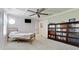 Bright bedroom featuring a ceiling fan, coffered ceilings, plantation shutters, and a built-in bookcase at 9403 9Th Nw Ave, Bradenton, FL 34209
