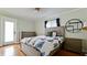 Cozy bedroom with hardwood floors, light-filtering shutters, and modern decor at 9403 9Th Nw Ave, Bradenton, FL 34209