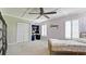 Charming bedroom with unique wallpaper, coffered ceilings, a ceiling fan, and built-in desk at 9403 9Th Nw Ave, Bradenton, FL 34209