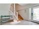 Bright entryway with wooden stairs, custom bench, and natural light, enhancing a welcoming ambiance at 9403 9Th Nw Ave, Bradenton, FL 34209