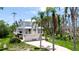 Charming two-story home with a inviting front porch, a well-manicured lawn, and lush tropical landscaping at 9403 9Th Nw Ave, Bradenton, FL 34209