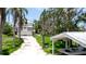 Exterior view of beautiful home with palm trees, lush landscaping, a covered parking area and boat at 9403 9Th Nw Ave, Bradenton, FL 34209