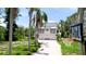 Exterior view of two-story home featuring a driveway, basketball hoop and lush landscaping at 9403 9Th Nw Ave, Bradenton, FL 34209