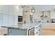 Modern kitchen with a large island, stainless steel appliances, and custom cabinets at 9403 9Th Nw Ave, Bradenton, FL 34209