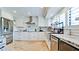 Contemporary kitchen with stainless appliances, white cabinets, and travertine floors at 9403 9Th Nw Ave, Bradenton, FL 34209