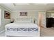 Stylish main bedroom with tray ceiling, plantation shutters, neutral tones, and elegant furnishings at 9403 9Th Nw Ave, Bradenton, FL 34209