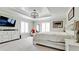 Spacious main bedroom with a tray ceiling, plantation shutters, a sitting area, and ample natural light at 9403 9Th Nw Ave, Bradenton, FL 34209