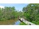Picturesque waterfront view of a private pier surrounded by lush greenery at 9403 9Th Nw Ave, Bradenton, FL 34209