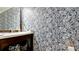 Chic powder room with bold floral wallpaper, a modern sink, and stylish accents at 9403 9Th Nw Ave, Bradenton, FL 34209