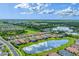 Expansive aerial view showcasing a picturesque community with ponds and well-maintained landscaping at 3025 Veneto Ct, Bradenton, FL 34211