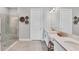 Bright bathroom featuring double sinks, quartz countertops and a glass enclosed shower at 3025 Veneto Ct, Bradenton, FL 34211