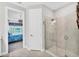 Modern bathroom featuring a glass enclosed shower and access to the primary bedroom at 3025 Veneto Ct, Bradenton, FL 34211
