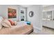 Bright bedroom with a twin bed, flamingo decor, and a bathroom en suite at 3025 Veneto Ct, Bradenton, FL 34211