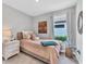 Cozy bedroom with a twin bed, flamingo decor, and lots of natural light from the window at 3025 Veneto Ct, Bradenton, FL 34211