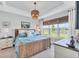 Stylish bedroom with a woven bedframe, neutral walls, and a view of the outdoor scenery at 3025 Veneto Ct, Bradenton, FL 34211