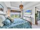 Bright bedroom featuring a woven bedframe, modern furniture, and a scenic lake view at 3025 Veneto Ct, Bradenton, FL 34211