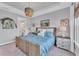 Comfortable bedroom with a woven bedframe, neutral walls, and an ensuite bathroom at 3025 Veneto Ct, Bradenton, FL 34211