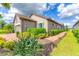 Charming home exterior with beautiful landscaping, a brick walkway and a tile roof at 3025 Veneto Ct, Bradenton, FL 34211