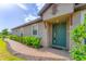 Inviting front entrance with a vibrant blue door, brick walkway, and lush greenery at 3025 Veneto Ct, Bradenton, FL 34211
