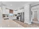 Bright kitchen featuring stainless steel appliances, white cabinetry, and quartz countertops at 3025 Veneto Ct, Bradenton, FL 34211
