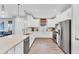 Spacious kitchen with white cabinets, stainless appliances, and an eat-in island with quartz countertops at 3025 Veneto Ct, Bradenton, FL 34211