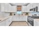 Well-equipped kitchen with stainless steel appliances, white cabinetry, and modern countertops at 3025 Veneto Ct, Bradenton, FL 34211