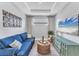 Living room featuring a comfy sofa, console table and a large TV with ocean scene at 3025 Veneto Ct, Bradenton, FL 34211