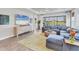 Comfortable living room with a large sectional couch, big windows and a modern TV at 3025 Veneto Ct, Bradenton, FL 34211