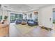 Spacious living room with a large sectional, tile flooring, and sliding glass doors at 3025 Veneto Ct, Bradenton, FL 34211