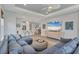 Inviting living room with kitchen view featuring a large sectional and modern TV at 3025 Veneto Ct, Bradenton, FL 34211