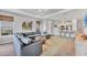 Open concept living room with a modern kitchen and a large sectional couch at 3025 Veneto Ct, Bradenton, FL 34211