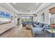 Comfortable living room with a large sectional couch, big windows and a modern TV at 3025 Veneto Ct, Bradenton, FL 34211