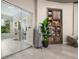 Relaxing lounge area with a robe on display, glass doors to the spa, and a decorative shelving unit at 3025 Veneto Ct, Bradenton, FL 34211