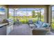 Screened in patio with beautiful lake view, outdoor kitchen, and comfortable seating area at 3025 Veneto Ct, Bradenton, FL 34211