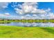 Expansive water view showcasing a tranquil pond reflecting the sky and surrounding homes at 3025 Veneto Ct, Bradenton, FL 34211