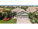 An aerial shot showcases a house with a nicely landscaped yard, complemented by a paver driveway at 11200 Whimbrel Ln, Sarasota, FL 34238