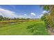 Enjoy serene backyard views of the lush green lawn and pond at 11200 Whimbrel Ln, Sarasota, FL 34238