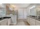 Bathroom featuring tiled floor, dual sinks, granite countertops, and walk-in shower at 11200 Whimbrel Ln, Sarasota, FL 34238