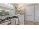 Bathroom featuring granite countertops, dual sinks, and a walk-in shower at 11200 Whimbrel Ln, Sarasota, FL 34238