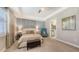 Bedroom with upholstered headboard, tray ceiling, soft carpet and ensuite bathroom at 11200 Whimbrel Ln, Sarasota, FL 34238