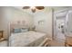 Bedroom featuring coastal decor, a ceiling fan, and an open doorway to the home's interior at 11200 Whimbrel Ln, Sarasota, FL 34238