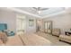 Spacious bedroom boasts neutral paint, tray ceiling, ceiling fan, and ensuite bathroom access at 11200 Whimbrel Ln, Sarasota, FL 34238